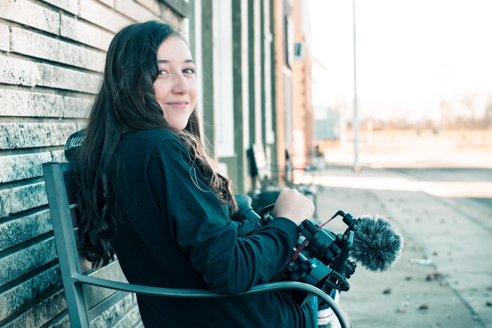 Student filmmakers setting up a camera on location