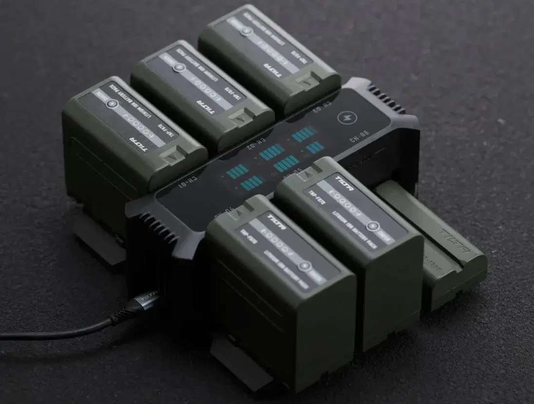 Tilta foldable charging station surrounded by six L-Series batteries
